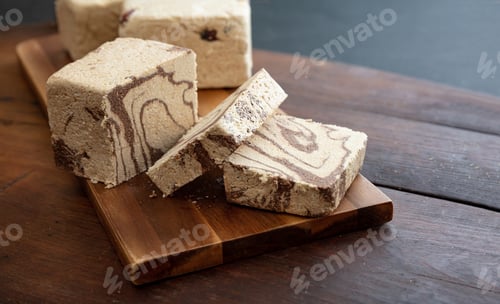 Preview: Halva cocoa slices on wooden table background, closeup view.