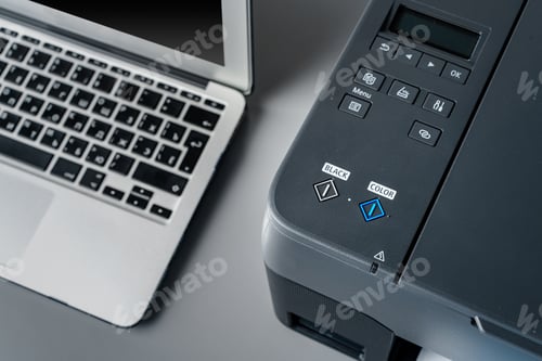 Preview: Printer and laptop on grey table in office
