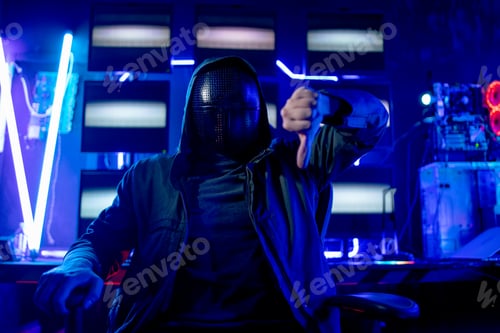 Preview: Man wear clothes look like hacker and sit with show thumbs down sign to the front