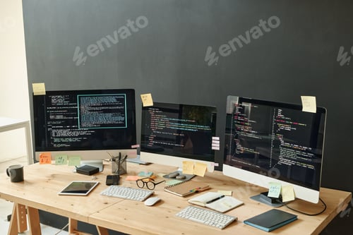 Preview: Three computer monitors with coded data and sticky notepapers on screens