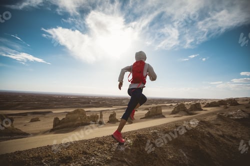 Preview: Woman trail runner cross country running on sand desert dunes