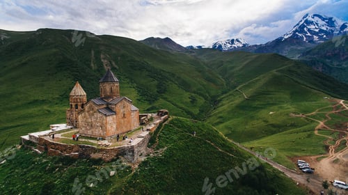 Preview: aerial view of old castle in green cloudy mountains, Georgia