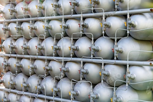 Preview: A lot of bottles filled with gas or gasoline are stacked in piles
