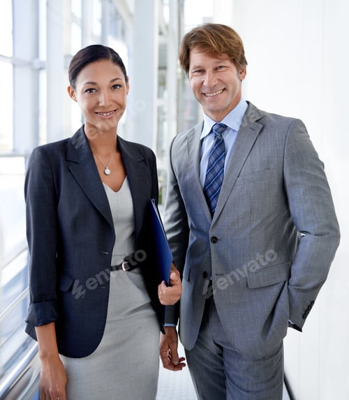 Preview: Working our way to the top. Shot of two professional colleagues in an office building.