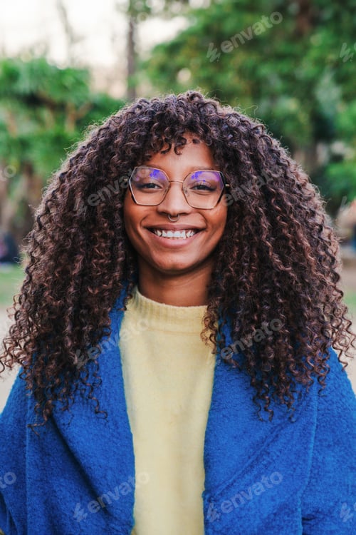Preview: Vertical close up portrait of young happy african american woman wearing goggles smiling looking at