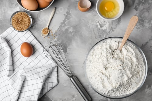 Preview: Composition with flour, eggs and brown sugar on grey background