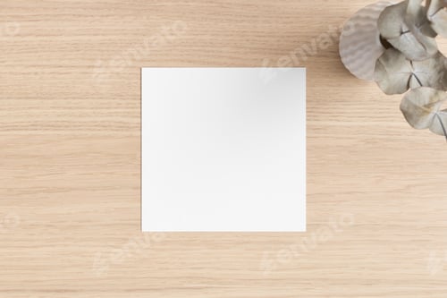 Preview: Square invitation card mockup with an eucalyptus on the wooden table.