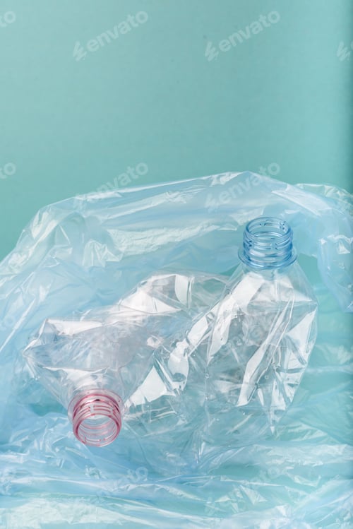 Preview: Used crushed plastic bottles on blue background.