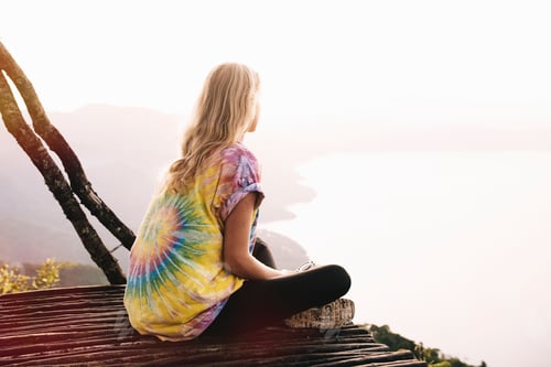 Preview: Young woman sitting on balcony looking out over Lake Atitlan, Guatemala
