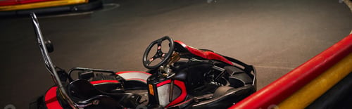Preview: go kart for racing or red racing car inside of indoor kart circuit, motor race vehicle, banner