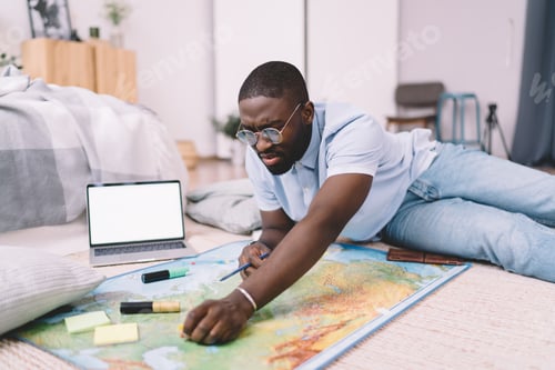 Preview: Black male choosing travel places on map