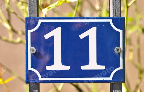 Preview: Closeup shot of a blue sign with the number 11 on the blurry background