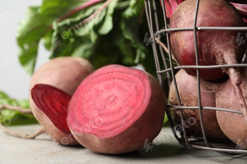 Preview: Cut fresh ripe beets on light grey table, closeup