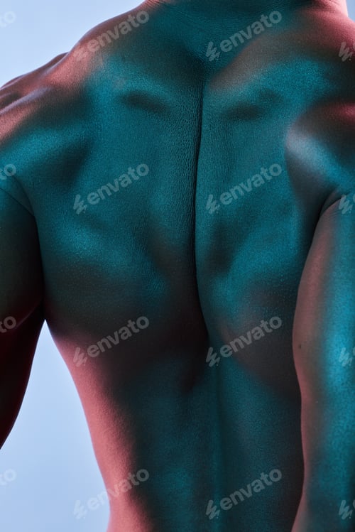 Preview: Shot of a muscular man posing against a studio background