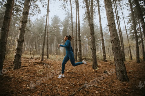Preview: Young woman running toward camera on the forest trail at autumn