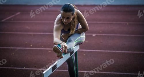 Preview: beautiful sporty girl warming up at the stadium,