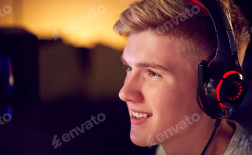 Young Man Gaming with Headset in Dark Room