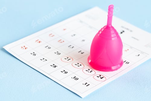 Preview: Calendar page and menstrual cup close up