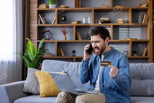 Preview: Annoyed Man with Card and Phone at Home