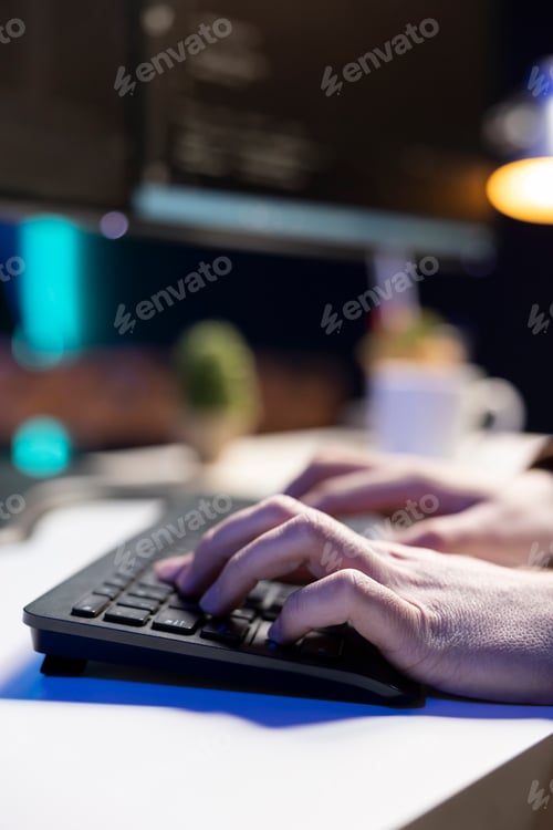 Preview: Computer scientist walking in apartment designing software using laptop