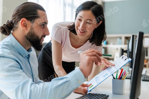 Preview: Successful colleagues, businessman and businesswoman, Arab man and Asian woman working together