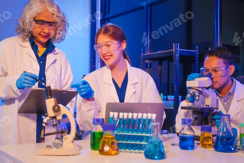 Preview: Two Asian men and women sit at a table in a laboratory, conducting research on liquids. They use