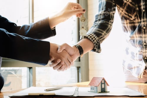 Preview: Real estate agent and customers shaking hands together celebrating finished contract after about
