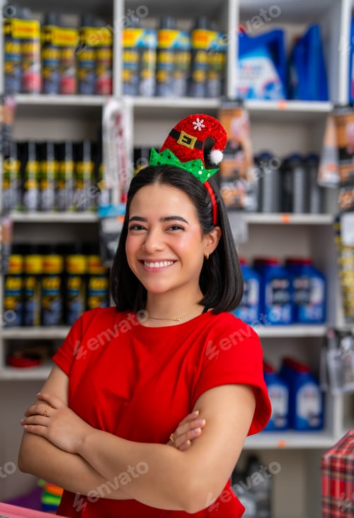 Preview: Woman standing with arms crossed, promoting holiday cheer in a car parts store