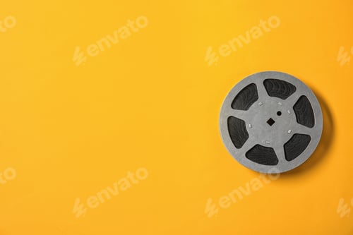 Preview: Movie reel on color background, top view with space for text. Cinema production