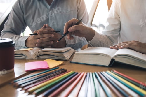 Preview: Teenage student works on homework in his room and writing in notebook.