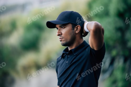 Preview: Young tennis player adjusting his cap during a match