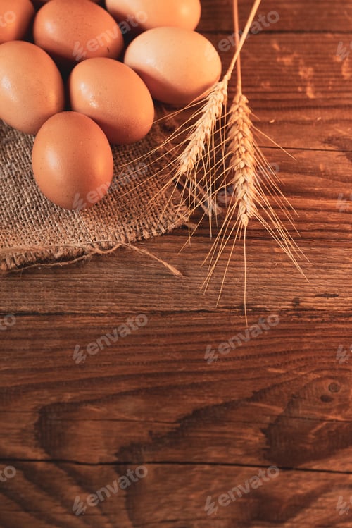 Preview: Brown eggs on a burlap on an old wooden table