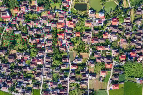 Preview: Rustic village settlement with roof houses on green field in suburban at Bac Son Valley