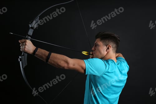Preview: Man with bow and arrow practicing archery on black background