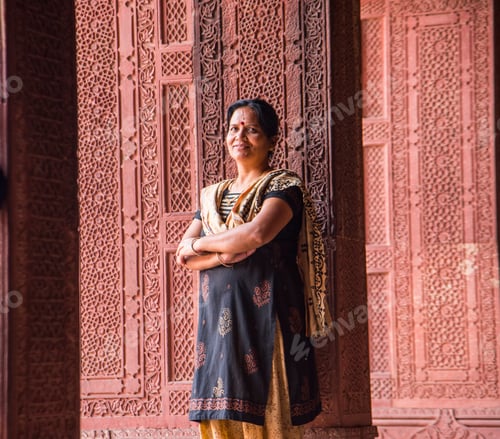 Preview: Young woman tourist at Red Fort, Agra, India.