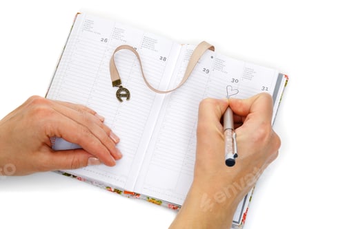 Preview: Notebook opened with female hands writing