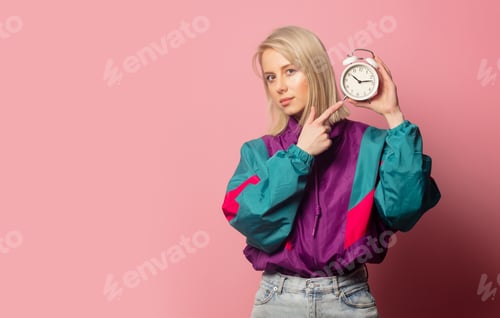 Preview: Beautiful blonde woman in 90s clothes with alarm clock