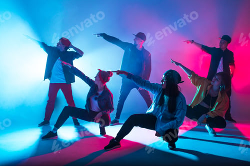 Preview: Group of diverse young hip-hop dancers in studio with special lighting effects