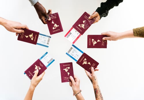 Preview: Group of Diverse Friendship Hands Show Passport with Plane Ticke