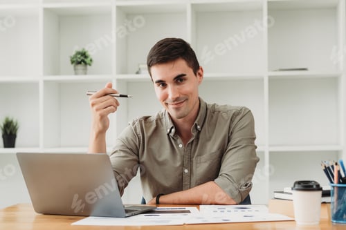 Preview: Businessman in shirt working on his laptop in an office. Open space office