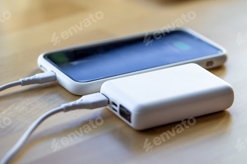 Preview: A smartphone is charged from a small white power bank.