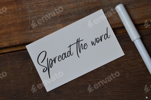 Preview: Top view of pen and memo note written with SPREAD THE WORD.