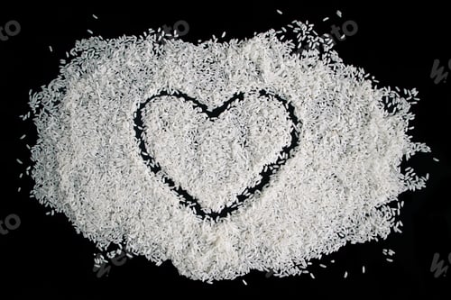 Preview: Heart-shaped rice on dark background. Love and valentines day concept.