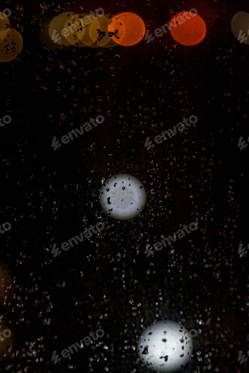 Preview: Raindrops Cascade Down the Glass Pane, Distorting the City Lights Beyond the Window