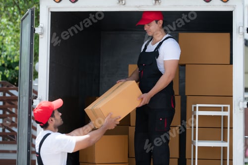 Preview: Asian delivery man in uniform delivering package to customer in back of truck.