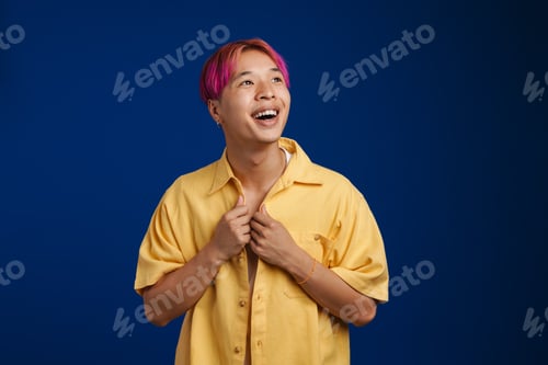 Preview: Asian boy with pink hair laughing and looking aside