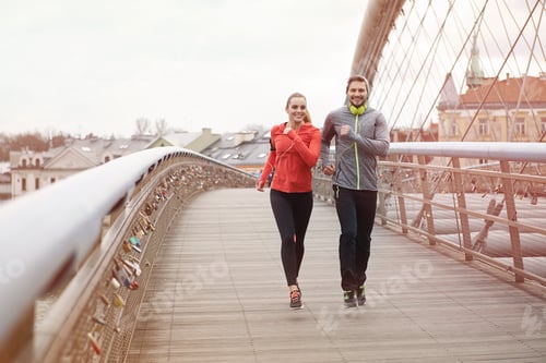 Couple enjoying fitness together on a bridge
