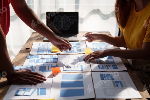 Preview: Group of ux developer and ui designer brainstorming about app interface design at modern office