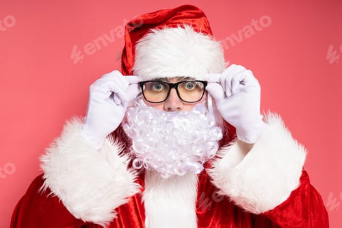 Preview: Santa Claus in glasses on a pink background.
