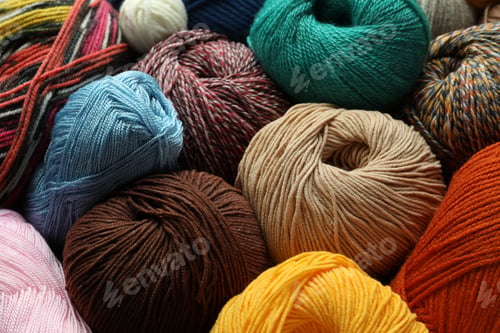 Preview: Different balls of woolen knitting yarns as background, closeup